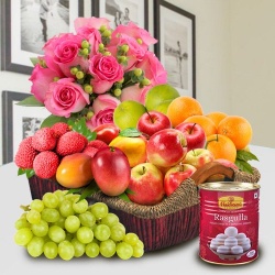 Mummys Delight Basket of Fresh Fruits and Haldiram Rasgulla along with Pink Rose Bouquet.