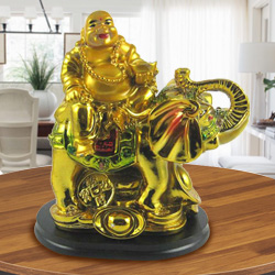 Laughing budha sitting on elephant
