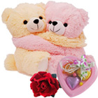 Cute Hugging Couple Teddy with 1 Velvet Rose and 3 pcs Heart Homemade Chocolate