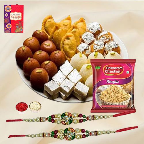 Magnificent Twin Rakhi Set with Assorted Sweets N Snacks
